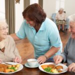 Meals On Wheels Ireland background-Senior Couple Being Served Meal